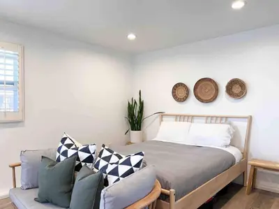 a bedroom with a bed and a couch at The Cozy Oasis - A Renovated and Modern Studio near LAX + SoFi + Beaches + Freeway in Lawndale