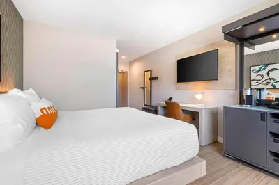 a hotel room with a bed and a flat screen tv at Cambria Hotel Burbank Airport in Burbank
