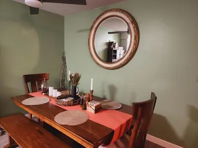 a dining room table with a mirror on the wall at Cozy Private Room & Bath Central Location LA in Los Angeles