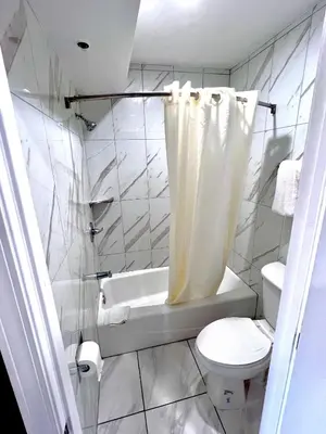 a bathroom with a toilet and a tub and a sink at Paradise Inn-Montebello,Los Angeles in Montebello