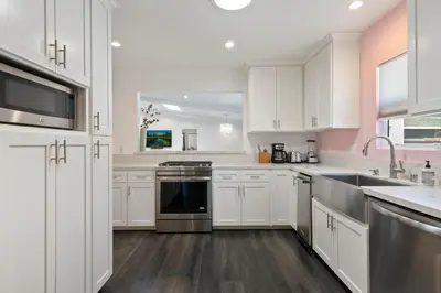 a kitchen with white cabinets and a stove top oven at Lovely North Hollywood House Near Universal in North Hollywood