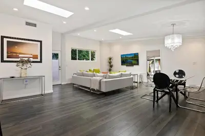a living room with a couch and a table at Lovely North Hollywood House Near Universal in North Hollywood