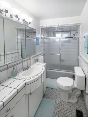 a bathroom with a sink and a toilet and a shower at Quaint Mid-Century Cottage by the Coast in Ventura