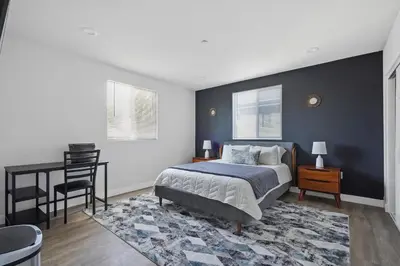 a bedroom with a bed and a desk with a chair at Good Shepard Homestay in Los Angeles