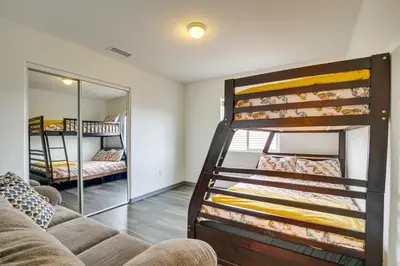 a living room with bunk beds and a couch at Family Helendale Home - Private Dock and Fire Pit! in Helendale