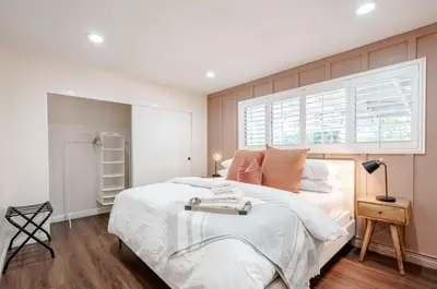 a bedroom with a large bed and a window at Elegant Retreat w/ Game room in Heart of OC in Midway City