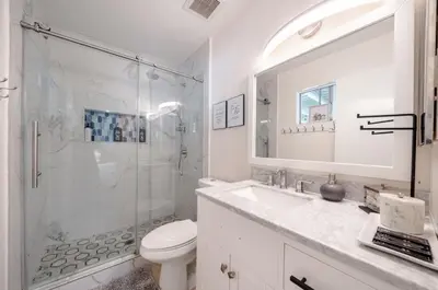 a white bathroom with a sink and a shower at Elegant Retreat w/ Game room in Heart of OC in Midway City