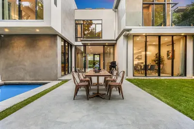 a patio with a table and chairs in front of a house at Coldwater Canyon in Los Angeles