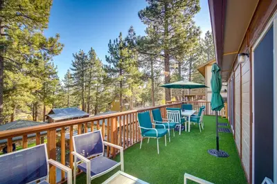 a deck with chairs and an umbrella at 1 Mi to Lake Home with Hot Tub and Gazebo in Big Bear in Big Bear Lake