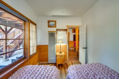 a bedroom with a bed and a window at 1 Mi to Lake Home with Hot Tub and Gazebo in Big Bear in Big Bear Lake
