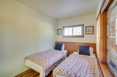 two beds in a small room with a window at 1 Mi to Lake Home with Hot Tub and Gazebo in Big Bear in Big Bear Lake