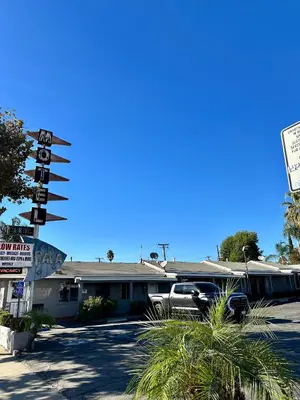 a building with a truck parked in front of it at Pala Motel in Pomona