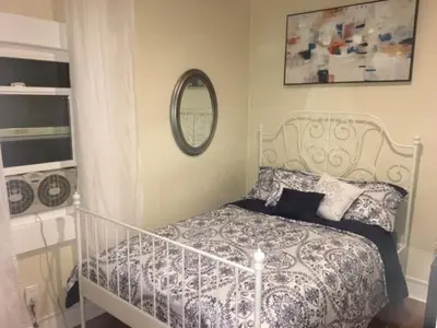 a bedroom with a white bed and a mirror at DTLA Oasis Private Bedroom with Exclusive Laundry - Steps to the Heartbeat of LA in Los Angeles
