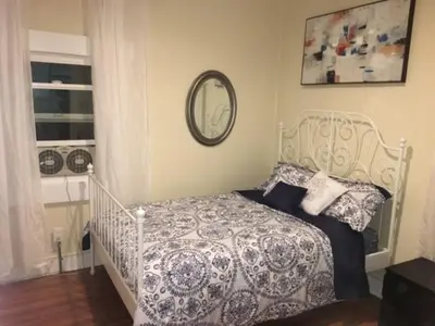 a bedroom with a white bed and a mirror at Urban Oasis with Private Laundry: Steps from DTLA in Los Angeles