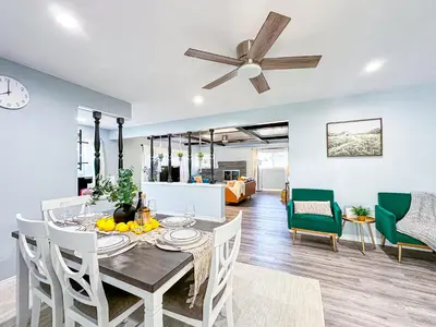 a dining room and living room with a table and chairs at Retreat Minutes To LAX, Manhattan/ Redondo Beach in Torrance