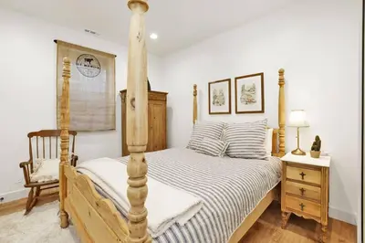 a bedroom with a four poster bed and a chair at Pine Meadow Village Castle~ Incredible Chalet Home in Big Bear Lake