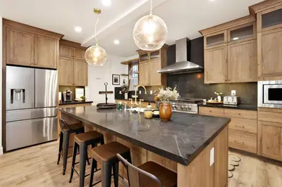 a kitchen with a large island with bar stools at Pine Meadow Village Castle~ Incredible Chalet Home in Big Bear Lake