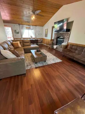 a living room with a couch and a fireplace at Beautiful, family friendly cabin by Lake Gregory. in Crestline