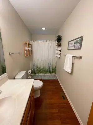 a bathroom with a sink and a toilet and a shower at Beautiful, family friendly cabin by Lake Gregory. in Crestline