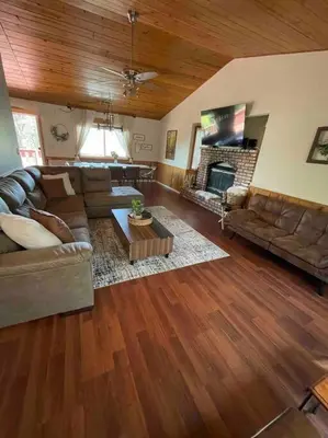 a living room with a couch and a fireplace at Beautiful, family friendly cabin by Lake Gregory. in Crestline