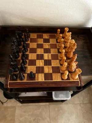 a wooden chess board with a chess set on it at Buxton Room in Rialto