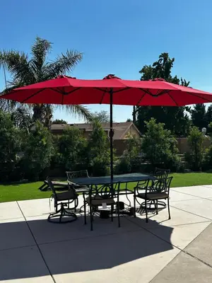 a table and chairs under a red umbrella at Buxton Room in Rialto