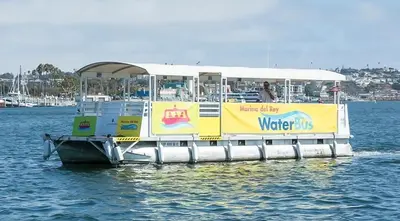 a ferry boat with a sign on the water at Amber Tide - Bright 1BR Marina Gem Ocean View in Los Angeles