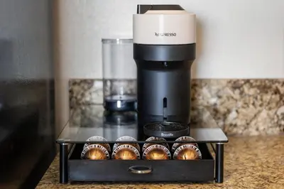 a coffee maker with cupcakes on a table at Amber Tide - Bright 1BR Marina Gem Ocean View in Los Angeles