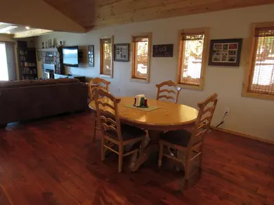 a living room with a wooden table and chairs at Smith Lakefront Hideaway in Big Bear Lake