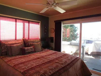 a bedroom with a bed and a ceiling fan at Smith Lakefront Hideaway in Big Bear Lake