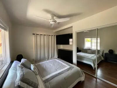 a bedroom with a bed and a ceiling fan at Your home away from home in beautiful Santa Monica in Los Angeles