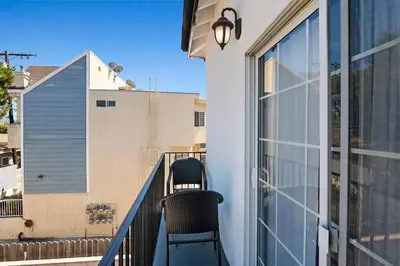 a balcony with two chairs sitting on a railing at Spacious Private gated modern loft close to Universal Studio and Hollywood in Los Angeles