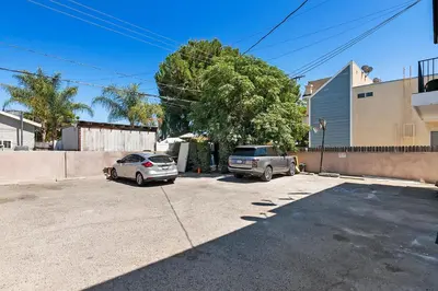 two cars are parked in a parking lot at Spacious Private gated modern loft close to Universal Studio and Hollywood in Los Angeles