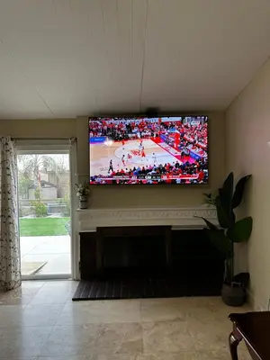 a living room with a large flat screen tv at Buxton Mirror Room in Rialto