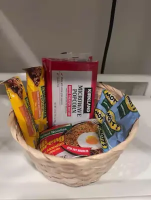 a basket filled with different types of snacks at Cozy Room with Private bathroom & Entrance in Carson