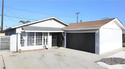 a white house with a garage at Cozy Room with Private bathroom & Entrance in Carson