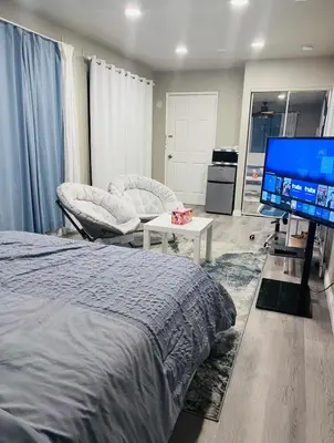 a bedroom with a bed and a flat screen tv at Cozy Room with Private bathroom & Entrance in Carson