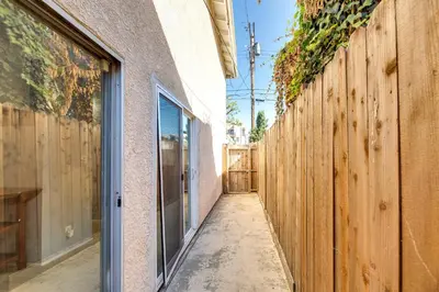 a walkway between two buildings with a wooden fence at 3 Mi to Universal Studios North Hollywood Home in North Hollywood
