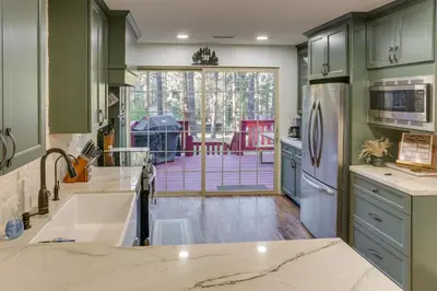 a kitchen with a large sink and a patio at Cozy Wrightwood Cabin Family and Pet Friendly! in Wrightwood