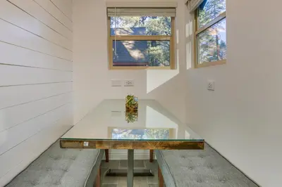 a glass table in a room with two windows at Cozy Wrightwood Cabin Family and Pet Friendly! in Wrightwood