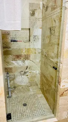 a bathroom with a shower with a stone wall at Private Room View Gated 2Acre Estate - Female Share Indoor - Men Share Outdoor - SD in Encino
