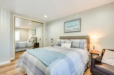 a bedroom with a large bed and a chair at Cozy Simi Valley Studio Less Than 10 Mi to Hiking and Golf in Simi Valley