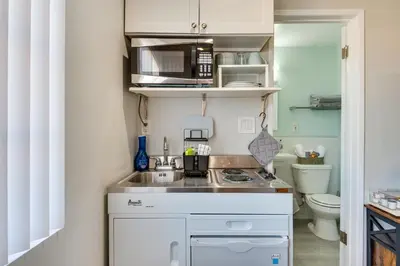 a small kitchen with a sink and a microwave at Cozy Simi Valley Studio Less Than 10 Mi to Hiking and Golf in Simi Valley