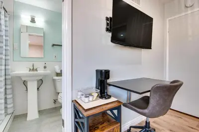 a bathroom with a desk and a television on the wall at Cozy Simi Valley Studio Less Than 10 Mi to Hiking and Golf in Simi Valley