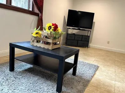 a living room with a table with flowers on it at Holiday at Halliday in Los Angeles
