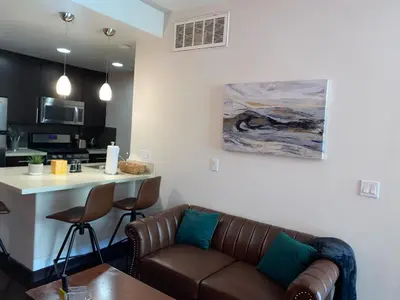 a living room with a couch and a kitchen at Spacious and Stylish unit in Los Angeles