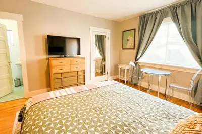 a bedroom with a bed and a flat screen tv at Peaceful 1BR Suite, Yurt and Barn in Cypress Park in Glendale