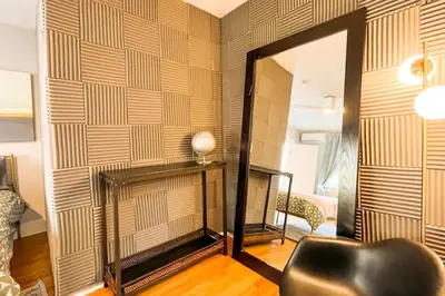 a living room with a mirror and a chair at Peaceful 1BR Suite, Yurt and Barn in Cypress Park in Glendale