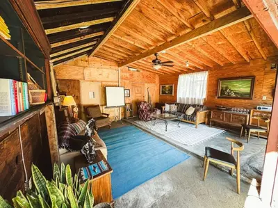 a living room filled with furniture and a wooden ceiling at Peaceful 1BR Suite, Yurt and Barn in Cypress Park in Glendale