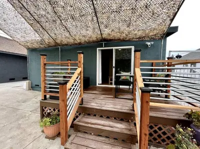a wooden deck with a roof and a chair at Serene Studio, Yurt Barn near DTLA Silverlake in Glendale